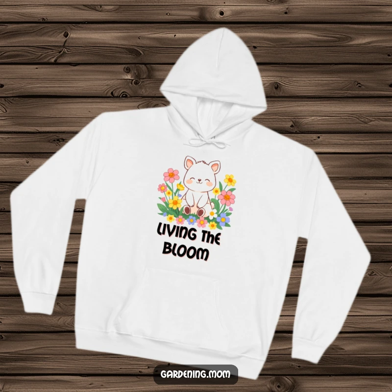 Funny contented animal character sitting amongst vibrant flowers with a peaceful smile, on a warm and cozy hoodie.